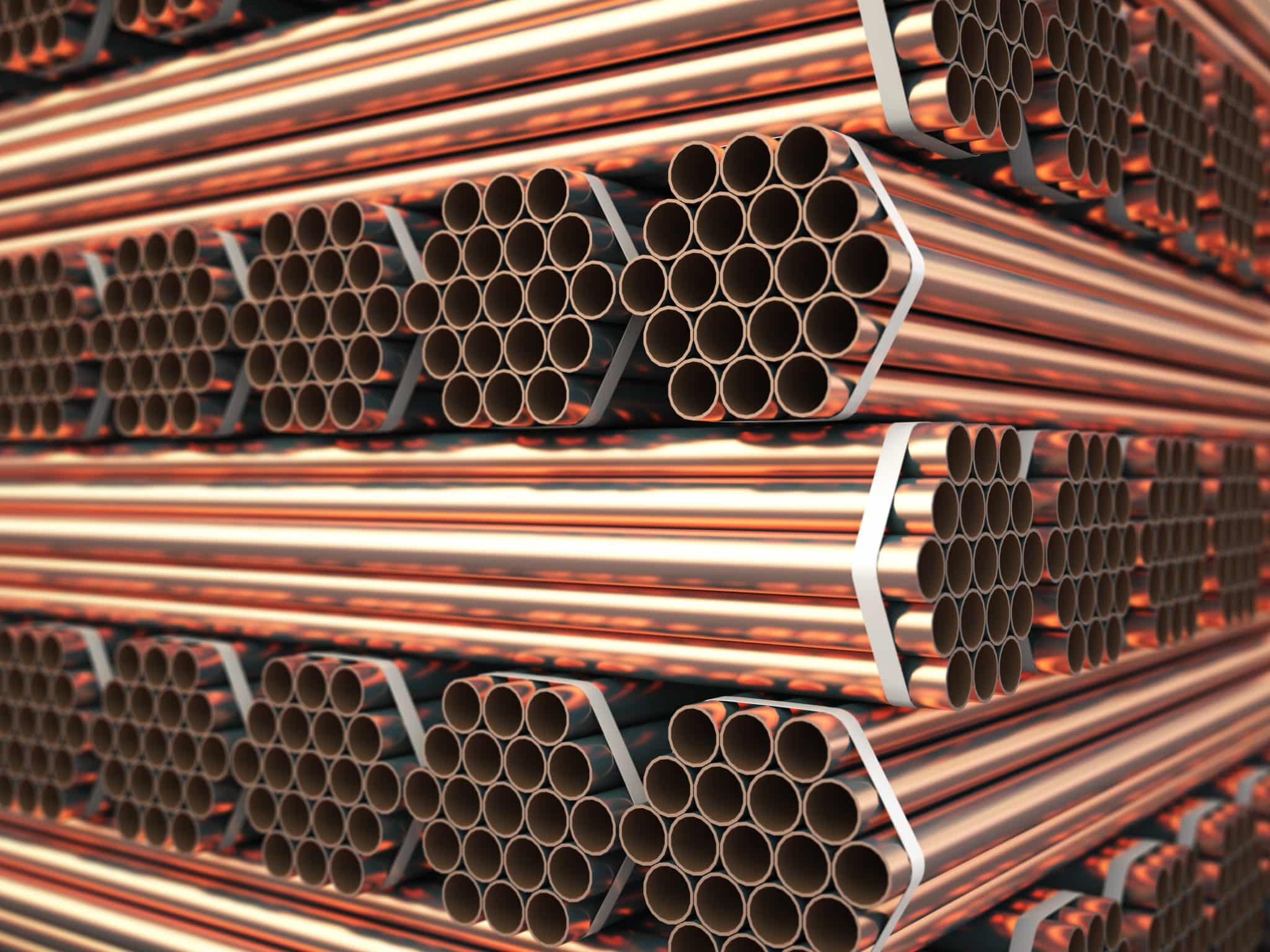 Copper or bronze metal pipes in warehouse. Heavy non-ferrous met