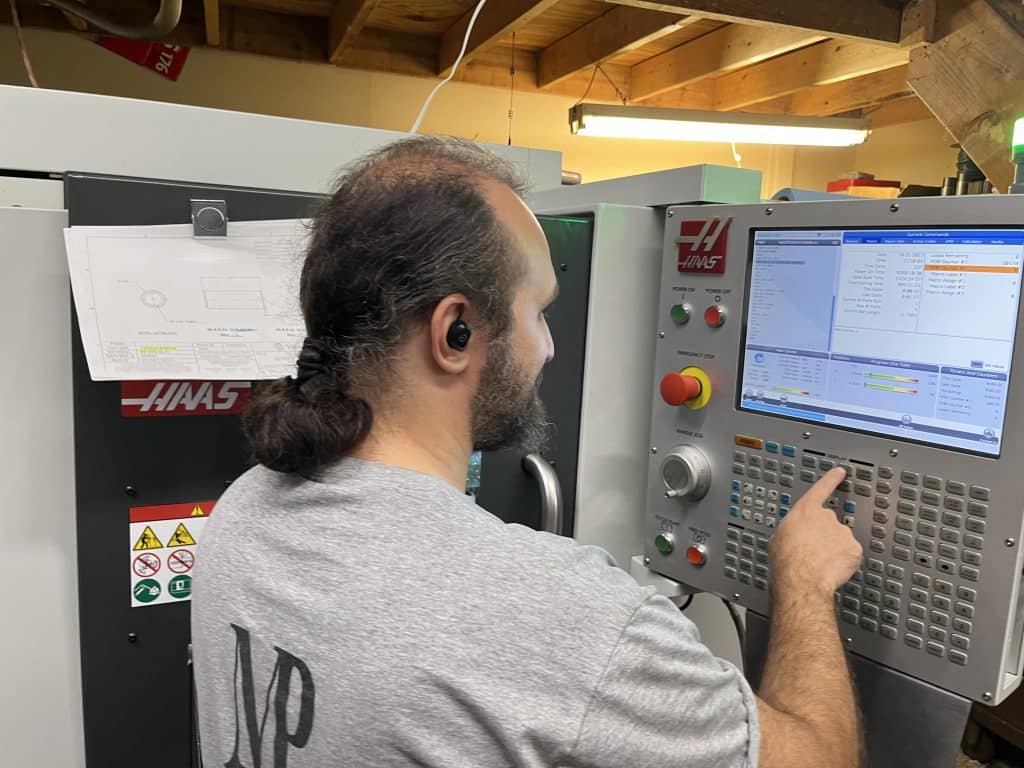 Man programming a CNC milling machine