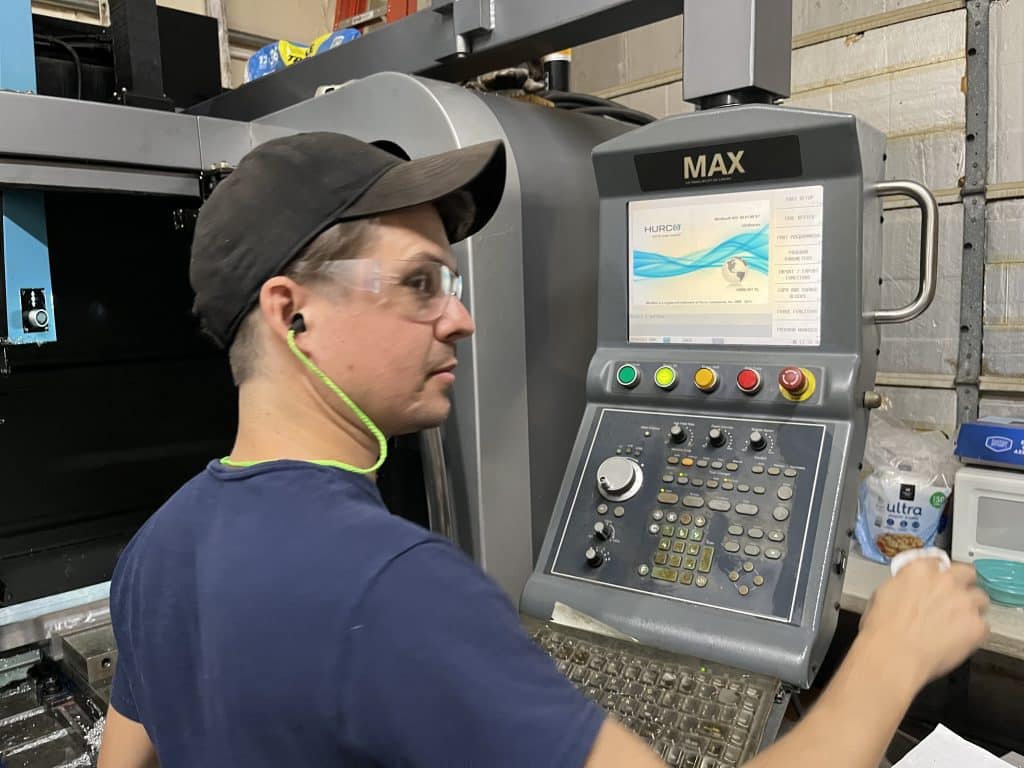 man making parts at a CNC Milling machine